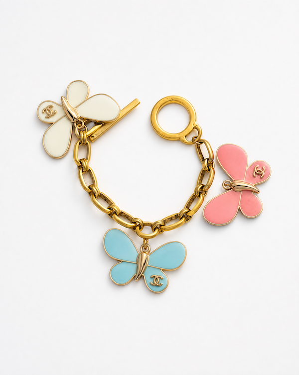chanel butterfly charms on a gold chain