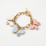 chanel butterfly charms on a gold chain